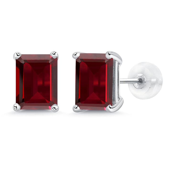Emerald-cut deep red gemstone stud earrings set in four-prong white gold