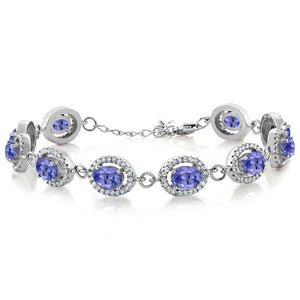 Sterling silver tennis bracelet with oval blue-purple gemstones framed by sparkling halo accents