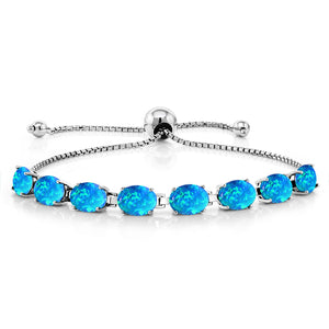 Adjustable sterling silver bolo bracelet with eight prong-set oval blue opal stones on a box chain